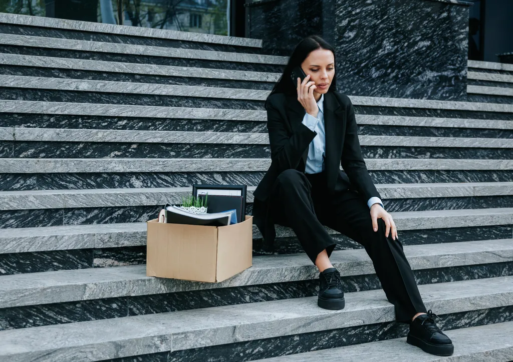 Woman who just got firec sitting on steps