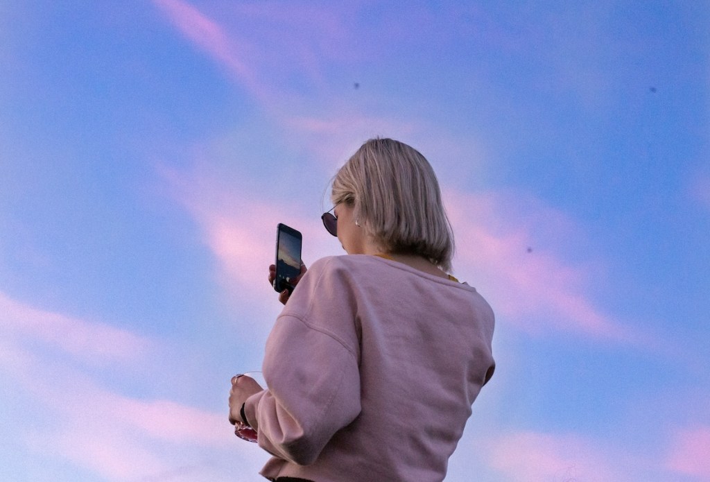 woman on cell looking at sky