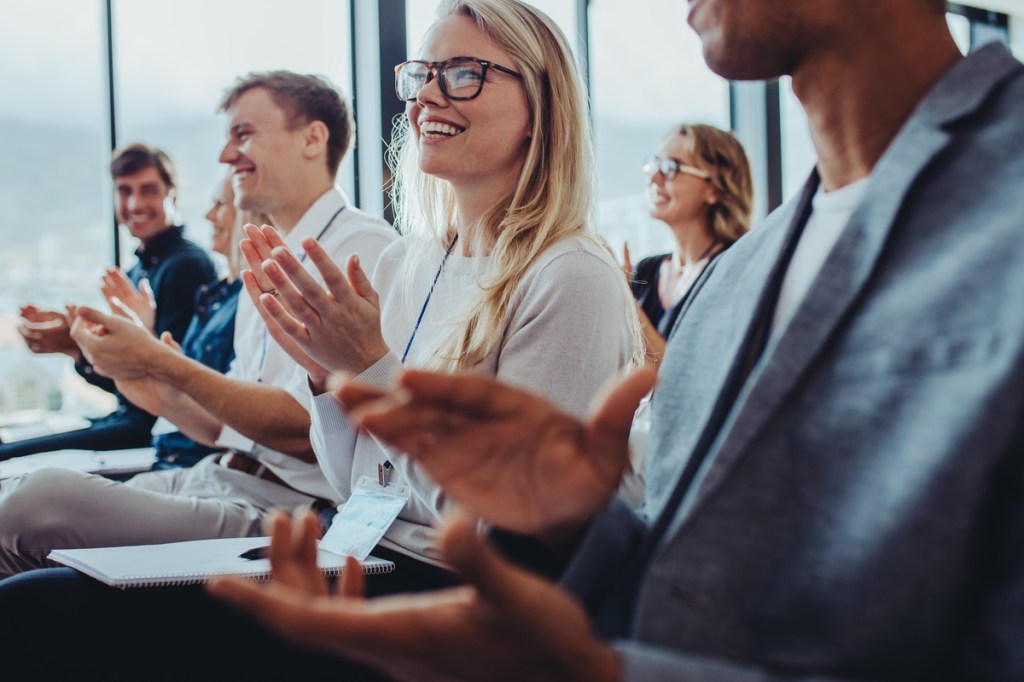 business professionals clapping at an event