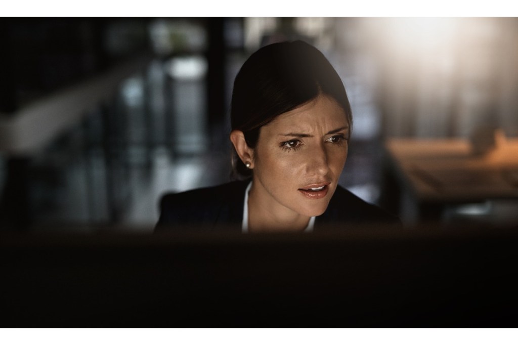 businessperson in front of computer being scammed