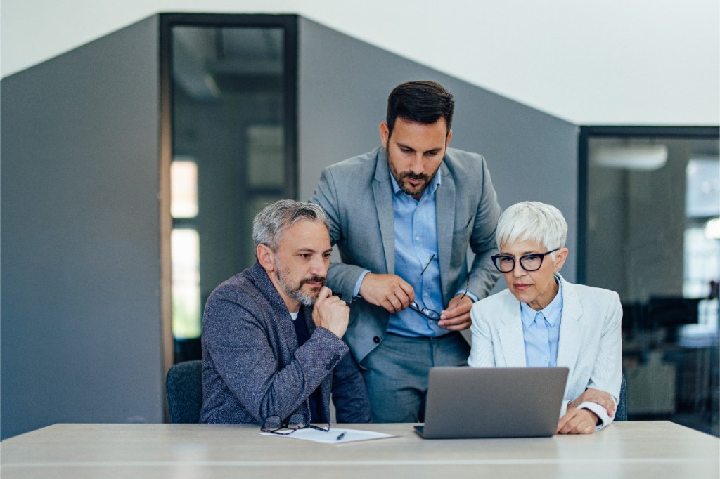 Businesspeople looking at laptop