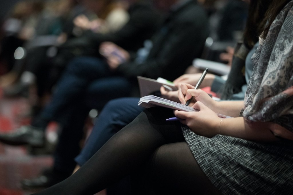 person taking notes at meeting